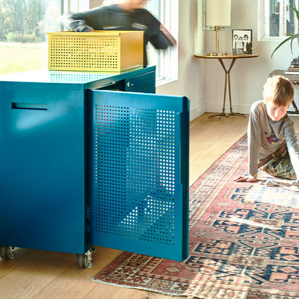 Heartwork Active Duty assistant in teal in home setting with child playing