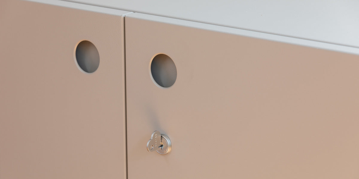 Detail of Heartwork Building Block cabinet showing porthole handles and a heart-shaped key